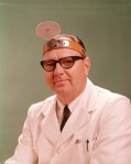 1950s 1960s Doctor Wearing Diagnostic Head Mirror On Forehead