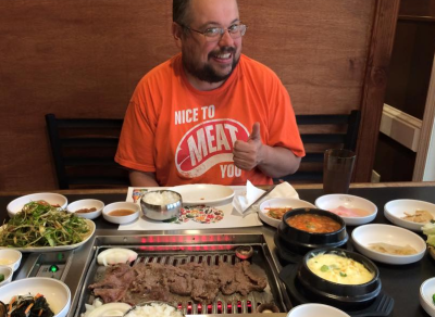 Schropp sits before the bowls of meat.