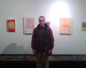 Dunn, standing in front of a wall.